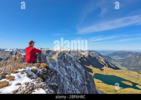 Homme assis à un sommet de montagne. Alpes d'Allgau, Bavière, Allemagne Banque D'Images