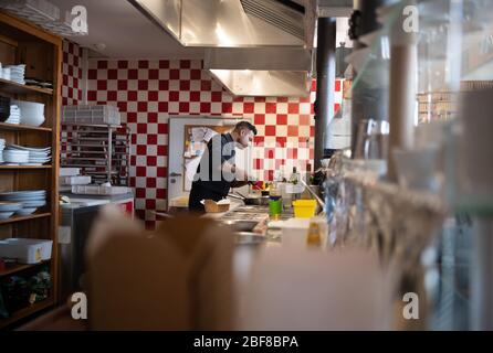 Potsdam, Allemagne. 7 avril 2020. Le chef Shakeel prépare une partie de la penne avec la salsiccia dans le restaurant 'Genusswerkstatt' au Filmmuseum, l'accent étant mis sur les boîtes pour les "commandes hors de la maison". Les clients ne sont pas autorisés à s'asseoir et à manger dans les restaurants pendant les restrictions imposées par le Corona danger. Crédit: Soeren Stache/dpa-Zentralbild/ZB/dpa/Alay Live News Banque D'Images