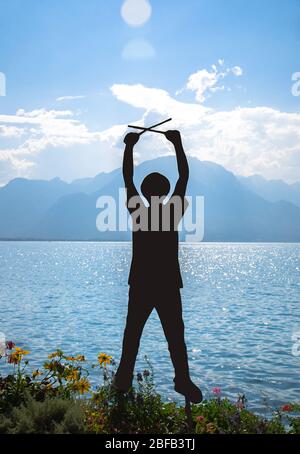 Montreux, Suisse - 14 septembre 2017 : silhouette figurée d'un homme dans un chapeau avec des pilons sur la promenade du lac Léman (lac Léman) en face Banque D'Images