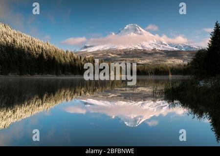 Les nuages en début de matinée révèlent une partie de la neige fraîche d'automne sur le plus haut sommet de l'Oregon, le Mt Hood se reflétant dans le lac Trillium. Banque D'Images