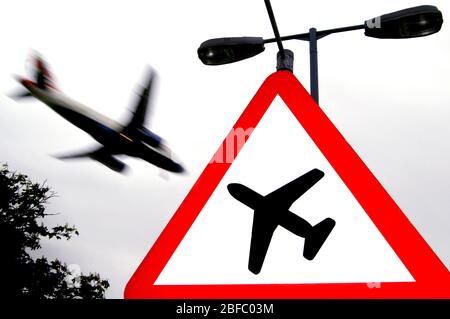 Un avion volant au-dessus des panneaux routiers près de l'Aéroport International d'Heathrow, Londres. Banque D'Images