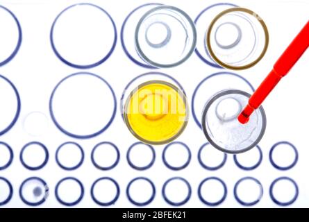 Pipetage de liquide rouge dans des tubes à essai. (Medicamage) Banque D'Images
