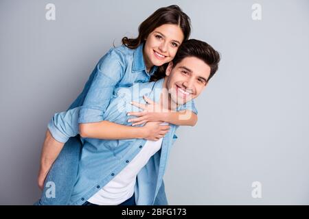 Portrait d'un étudiant passionné positif couple homme hug embrasser piggyback femme profiter romantique date ensemble porter style décontracté vêtements de style de mode Banque D'Images