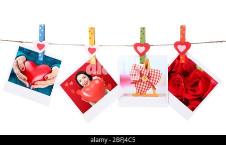 Cartes photo suspendues sur la ligne de vêtements isolées sur blanc, concept de Saint-Valentin Banque D'Images