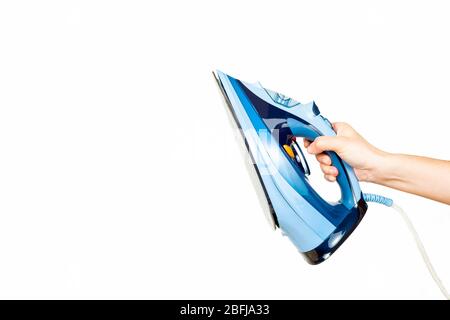main de la femme tenant un fer sur fond blanc Banque D'Images
