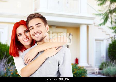 Couple aimant près de leur maison Banque D'Images