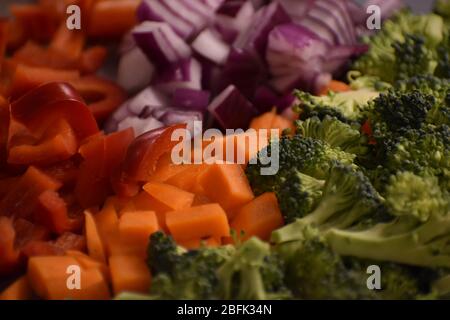 Une vue rapprochée de légumes mélangés en préparation dans une cuisine Banque D'Images