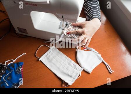 Jeune femme faisant maison a fait masque de respiration, protection du virus corona. Protéger la toux, la poussière, la pollution, la COVID-19 et toute autre contamination. Virus de couture f Banque D'Images