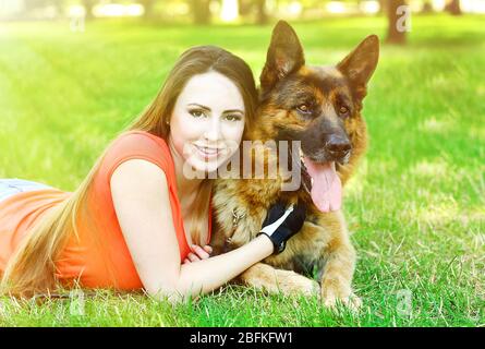 Belle jeune fille avec chien dans le parc Banque D'Images