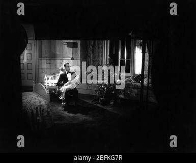 AL JOLSON chante la chanson '' Sonny Boy '' à DAVEY LEE sur set Candid filmant LE CHANTEUR FOU 1928 Lloyd BACON The Vitaphone Corporation - Warner Bros. Banque D'Images