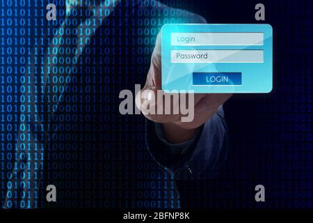 Homme d'affaires entrant le login et le mot de passe sur l'écran virtuel sur fond sombre. Concept de cyber-attaque et de sécurité Banque D'Images