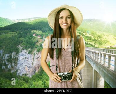 Jeune femme avec appareil photo sur un beau paysage Banque D'Images