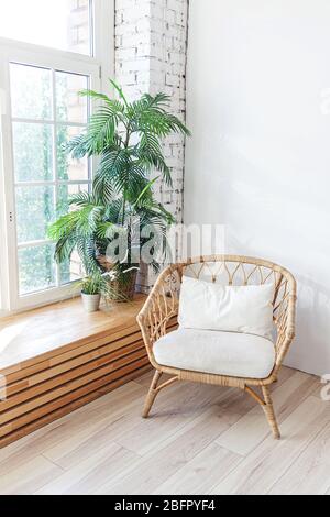 Intérieur élégant de la chambre en mezzanine. Cet appartement spacieux au design comprend de grandes fenêtres et un fauteuil aux murs clairs. Décoration moderne et propre, mobilier élégant, style scandinave minimaliste Banque D'Images