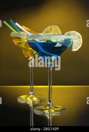 Cocktails jaunes et bleus dans des verres sur fond couleur Banque D'Images