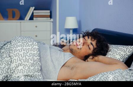 Man sleeping in bed at home Banque D'Images
