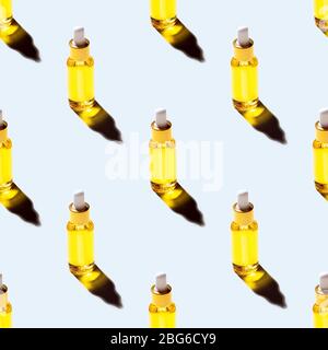 Modèle sans coutures de bouteille de verre avec des cosmétiques d'extraction d'huile de graines naturelles organiques pour les soins de la peau et des cheveux sur fond bleu pastel Banque D'Images