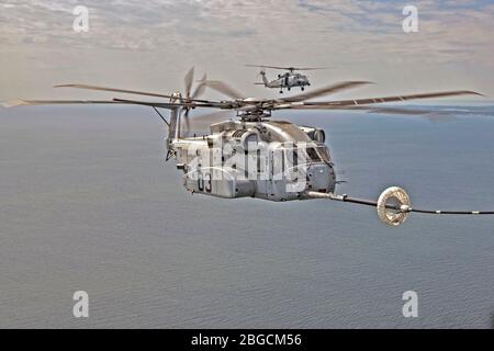 Le CH-53 K King Stallion se branche avec succès dans une drogue en forme d'entonnoir tractée derrière un KC-130 J lors des tests de réveil par ravitaillement aérien sur la baie de Chesapeake. Photo d'Erik Hildebrandt. Banque D'Images