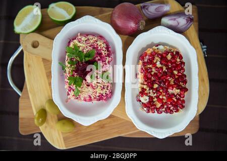 Betterave avec ail et mayonnaise. Salade panaméenne faite de pommes de terre, betteraves, œufs, oignons et mayonnaise . planche en bois Banque D'Images