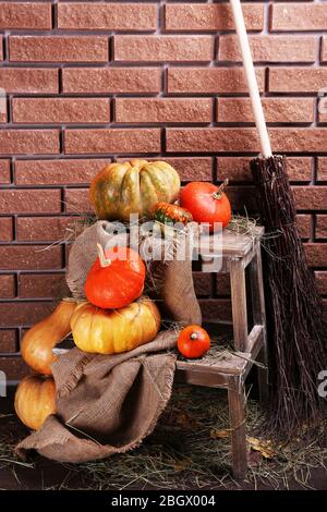 Citrouilles sur échelle en bois sur fond de mur de briques Banque D'Images