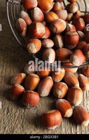 Noisettes dans le panier sur fond de bois Banque D'Images