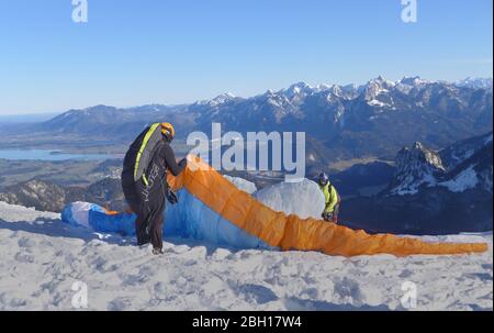 Parapentes lors de la préparation du départ dans la neige, Allemagne, Bavière, Alpes d'Allgaeu Banque D'Images