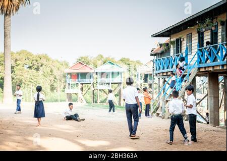 Les enfants cambodgiens jouent à l'extérieur de leur école locale dans le village flottant de Tonle SAP, Kampong Phluk, province de Siem Reap, Cambodge. Banque D'Images