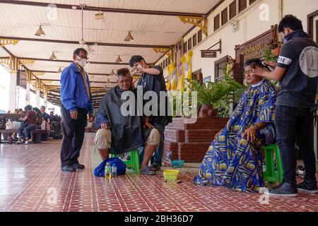 Coiffeur avec masques de visage à la gare d'Ayutthaya, Thaïlande Banque D'Images