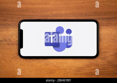 Un smartphone affichant le logo Microsoft Teams repose sur une table en bois ordinaire (usage éditorial uniquement). Banque D'Images