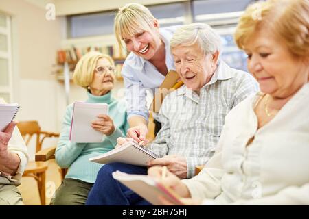 Le psychothérapeute aide les aînés démentés avec la thérapie de groupe dans une maison de retraite Banque D'Images