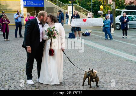 Dortmund, 24 avril 2020: Mariage à Corona Times. Un couple s'est marié le 24 avril. Devant le bureau du registre, les membres de la famille et les amis les ont félicités à distance de sécurité appropriée. Banque D'Images