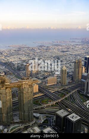 Dubai Centre-ville de von oben, gesehen von der Aussichtsplattform des höchsten Hauses der Welt, dem Burj Khalifa bei Sonnenaufgang mit Kreuzung der Sheikh Zayed Road als wichtigste Schnellstraße Dubais Banque D'Images