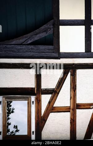 Le faisceau de la construction et le cadre en bois d'une maison à colombages nostalgique avec une façade jaune. Banque D'Images