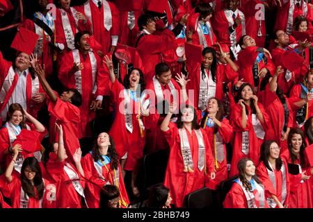 Houston Texas États-Unis, 29 mai 2010: Les aînés du secondaire lancent leurs mortarboards dans les airs pour célébrer la fin de leur cérémonie de remise des diplômes à l'Académie KIPP. KIPP est une école de charte publique reconnue au niveau national qui dessert principalement des étudiants minoritaires dans une région économiquement défavorisée du sud-ouest de Houston. ©Bob Daemmrich Banque D'Images