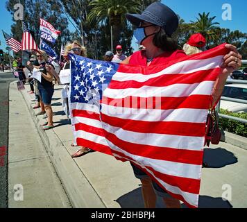 OpenUpCA, Newport Beach, Californie, 24 avril 2020, les manifestants se rallient autour de la périphérie de Newport Beach , agitant des drapeaux américains exigeant la réouverture de la Californie. Banque D'Images