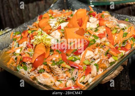 Poivrons rouges, orange et jaunes avec fruits de mer, persil et feuilles de salade, nouilles de riz. Spécialités asiatiques repas traditionnels au brunch ou au restaurant Banque D'Images