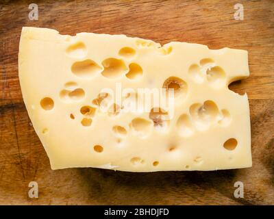 morceau de fromage suisse jaune sur table en bois près Banque D'Images