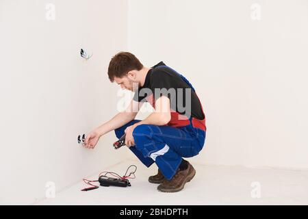 pince à sertir sur les mains de l'homme. installation, réparations dans le nouveau plat Banque D'Images