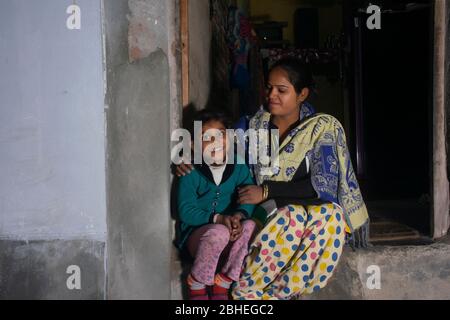 mère rurale indienne et fille assise à la porte de la maison Banque D'Images