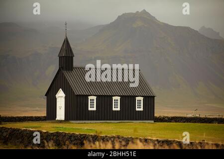 La petite église en bois noir près de Budir dans le nord de l'Islande. Banque D'Images