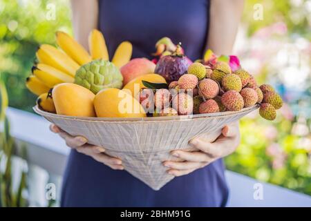 Variété de fruits dans un chapeau vietnamien. Femme dans un chapeau vietnamien Banque D'Images