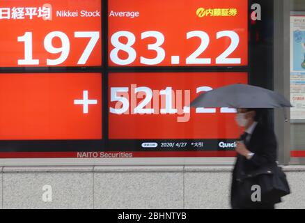 Tokyo, Japon. 27 avril 2020. Un passage piéton passe avant la planche à Tokyo le lundi 27 avril 2020. Les cours des actions japonaises ont augmenté de 521,22 yens pour se fermer à 19 783,22 yens à la Bourse de Tokyo. Crédit: Yoshio Tsunoda/AFLO/Alay Live News Banque D'Images