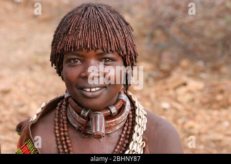 Portrait d'une femme Hamer Tribeswoman. Les cheveux sont recouverts de boue ocre et de graisse animale. Photographié dans la vallée de la rivière Omo, en Ethiopie Banque D'Images