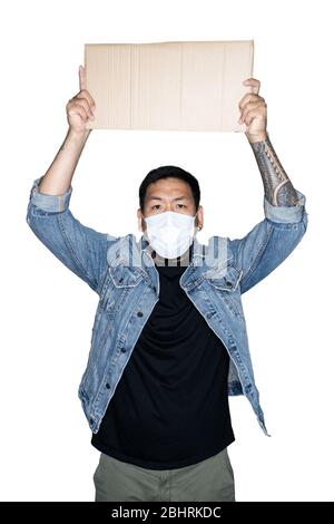 Le travailleur asiatique barbu vêtu d'un Jean avec masque médical tient du carton sur fond blanc. Le concept de protestation, attention, demande. Lieu Banque D'Images