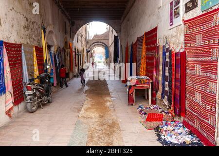 Allée avec magasin de tapis et tapis à Essaouira, Maroc Banque D'Images