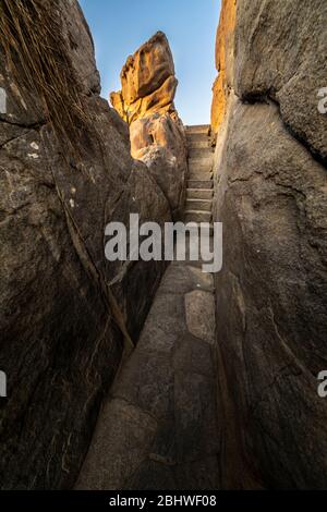 Un sentier magnifique et idyllique entre les rochers de granit en faisant un paysage fantastique d'un autre âge. Un pavé de pierre a coupé les falaises de la mer Banque D'Images