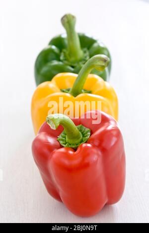 Trois poivrons doux brillants, rouge, vert et jaune - Banque D'Images