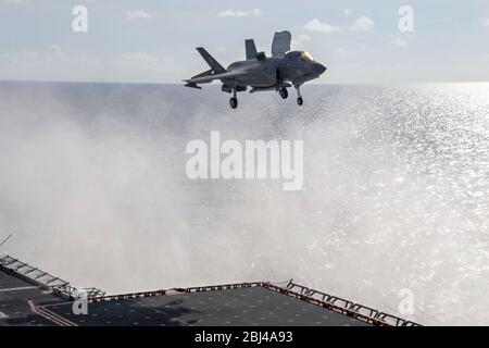 Un chasseur furtif F-35 B Lightning II du corps maritime américain, affecté à la 31ème unité expéditionnaire maritime, effectue un atterrissage vertical sur le pont de vol du navire-pilote d'assaut amphibie de classe américaine USS America lors d'opérations de routine le 23 avril 2020 en mer de Chine méridionale. Banque D'Images