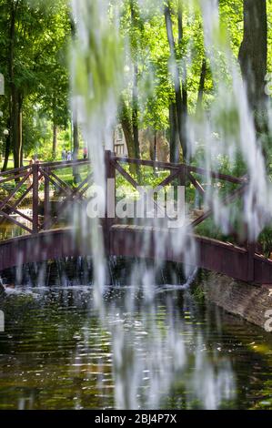 La chute de l'eau transparent flux vertical contre un ciel bleu et vert paysage, close-up Banque D'Images