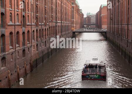 Hambourg, Allemagne - 30 novembre 2018 : bateau de plaisance avec touristes va sur Speicherstadt, ancien quartier d'entrepôts à Hambourg Banque D'Images