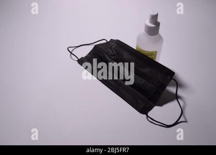 Masque protecteur et distributeur de gel aseptisant sur fond blanc, contre le coronavirus Novel (2019-nCoV) ou le coronavirus Wuhan et la grippe. ANTISE Banque D'Images